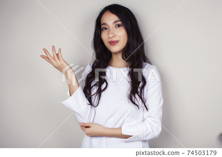 young asian woman doctor in white uniform gesturing positive on gray background, lifestyle healthcare people concept young asian woman doctor in white uniform gesturing positive on gray background, lifestyle healthcare people concept 74503179