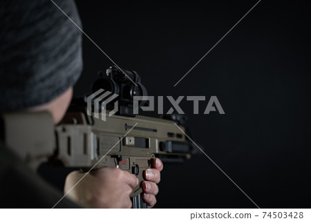 The person holding the assault rifle 74503428