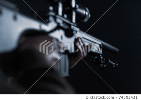 The person holding the sniper rifle 74503431