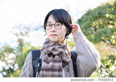 Young Japanese woman with short hair wearing glasses 74503653