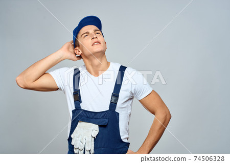 working man in uniform service lifestyle delivery service light background working man in uniform service lifestyle delivery service light background 74506328