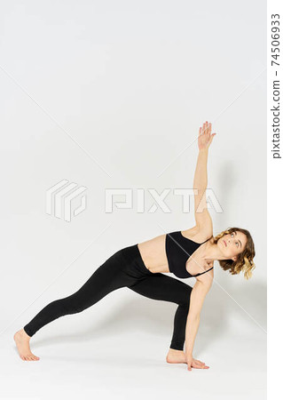 Woman in sportswear is engaged in fitness indoor gymnastics slim figure Woman in sportswear is engaged in fitness indoor gymnastics slim figure 74506933