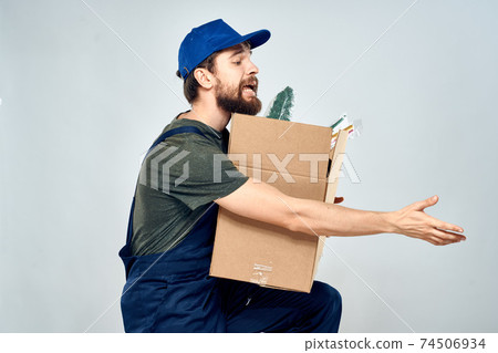 Male worker loading delivery boxes in hands packing lifestyle Male worker loading delivery boxes in hands packing lifestyle 74506934