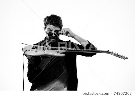 man with guitar in hands musician rock star performance lifestyle light background man with guitar in hands musician rock star performance lifestyle light background 74507202
