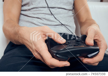 Gamepad male hands close-up video game addiction office technology 74507330