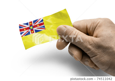 Hand holding a card with a national flag the Niue Hand holding a card with a national flag the Niue 74511042