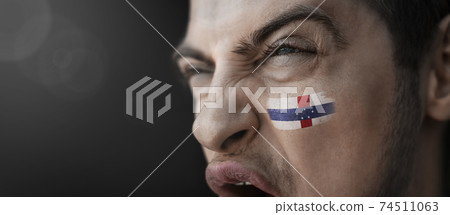 A screaming man with the image of the Netherlands Antilles national flag on his face A screaming man with the image of the Netherlands Antilles national flag on his face 74511063