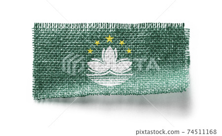 Macao flag on a piece of cloth on a white background 74511168
