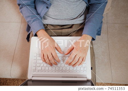 Businessman or student using laptop at home Businessman or student using laptop at home 74511353