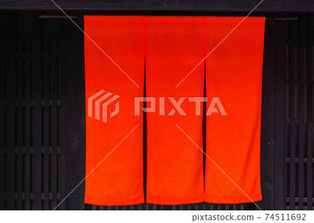 Noren of red cloth displayed in front of the entrance of the restaurant 74511692