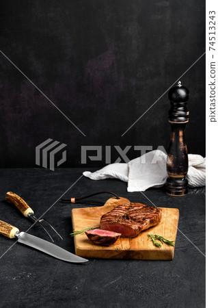Juicy steak on wooden cutting board Juicy steak on wooden cutting board 74513243