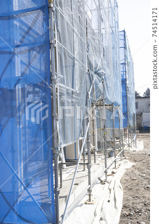 Scenery of a new housing construction site with scaffolding Scenery of a new housing construction site with scaffolding 74514171