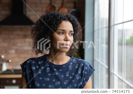 Close up upset African American woman looking to aside 74514175