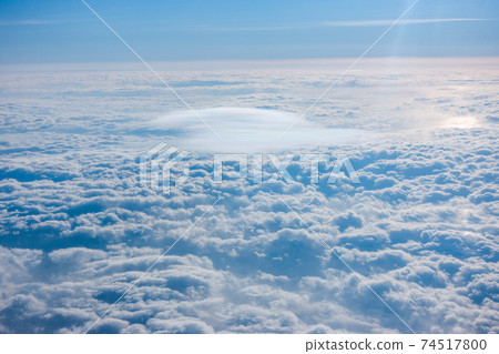 Sea of clouds seen from the window of an airplane Sea of clouds seen from the window of an airplane 74517800