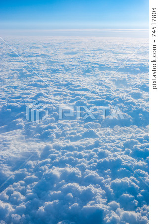 Sea of clouds seen from the window of an airplane Sea of clouds seen from the window of an airplane 74517803