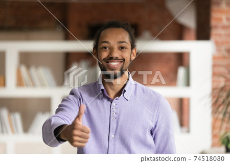 Portrait of smiling ethnic man show thumb up Portrait of smiling ethnic man show thumb up 74518080
