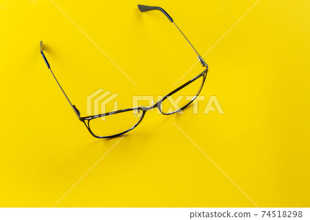 Stylish glasses on a yellow background. Stylish glasses on a yellow background. 74518298