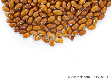 Dried orange beans on a white plate. Dried orange beans on a white plate. 74518621