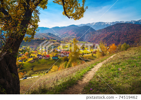 Colorful autumn scenery and Magura village with snowy mountains, Romania Colorful autumn scenery and Magura village with snowy mountains, Romania 74519462