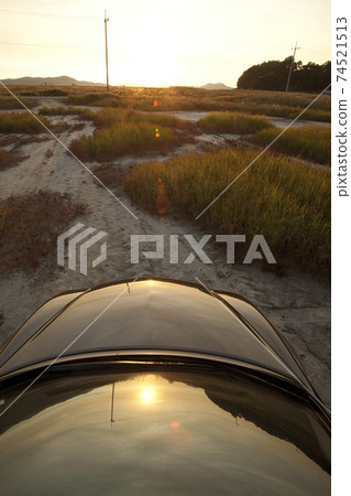 A car on a dirt road 74521513
