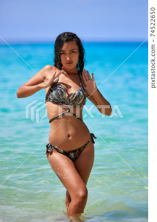 Sexy girl posing in the sunny day at the tropical beach 74522650