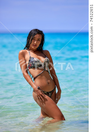 Sexy girl posing in the sunny day at the tropical beach Sexy girl posing in the sunny day at the tropical beach 74522651