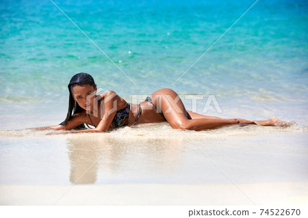 Sexy girl laying on the sand at tropical beach 74522670
