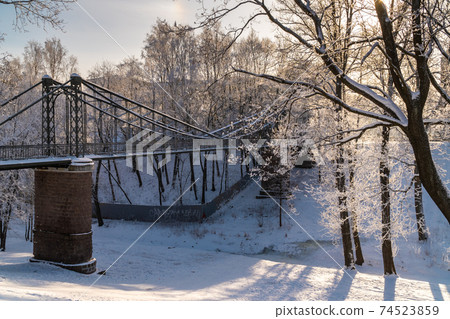 Russia. Winter view of the hanging Makarovsky Bridge over the ravine of the Petrovsky dock in Kronstadt. Russia. Winter view of the hanging Makarovsky Bridge over the ravine of the Petrovsky dock in Kronstadt. 74523859