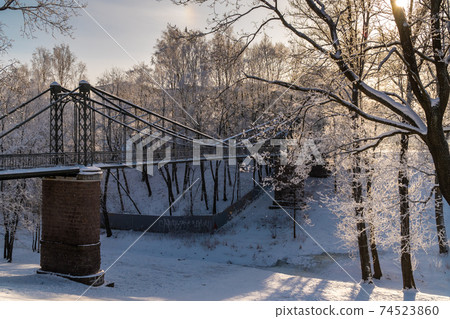 Russia. Winter view of the hanging Makarovsky Bridge over the ravine of the Petrovsky dock in Kronstadt. Russia. Winter view of the hanging Makarovsky Bridge over the ravine of the Petrovsky dock in Kronstadt. 74523860