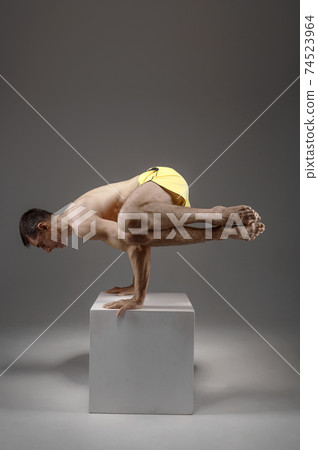 Yoga keeps balanc on hands in difficult pose Yoga keeps balanc on hands in difficult pose 74523964