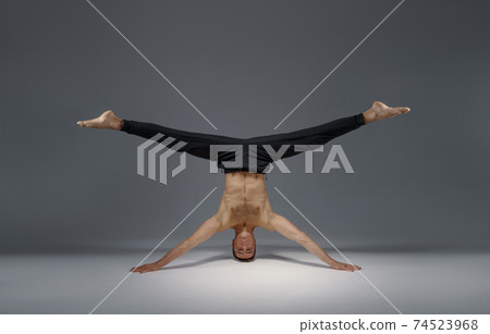 Male yoga standing on his head and hands Male yoga standing on his head and hands 74523968