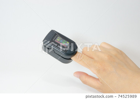 A pulse oximeter attached to your finger. Blood oxygen saturation and heart rate are digitally displayed on the LCD screen. 74525989