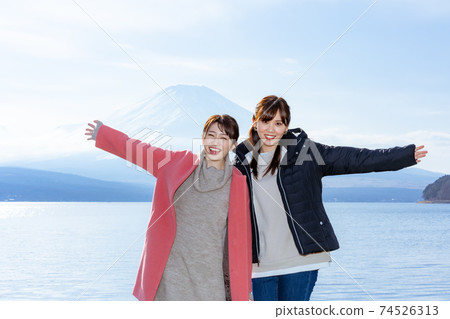 A woman enjoying Mt. Fuji from Lake Yamanaka A woman enjoying Mt. Fuji from Lake Yamanaka 74526313