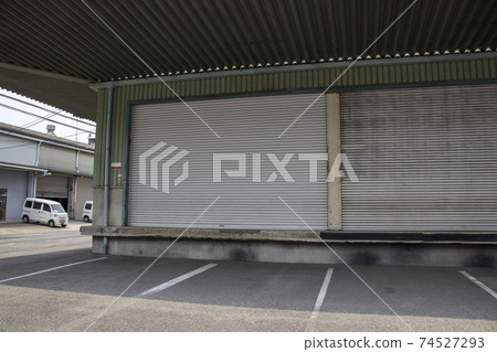 Warehouse with closed shutters Warehouse with closed shutters 74527293