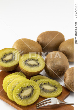 Green kiwi lined up on a white background 74527386