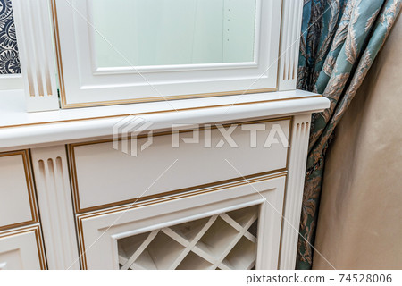 Classical style white showcase with glass doors and gilding closeup view 74528006