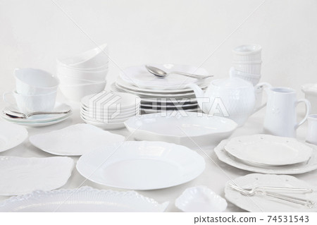 Lots of white tableware piled up 74531543
