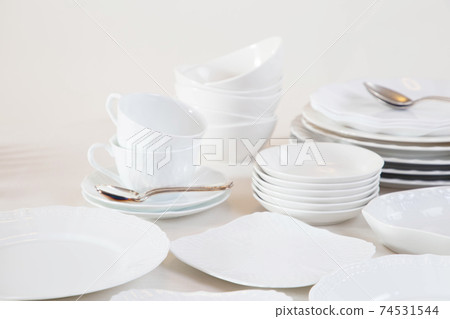 Lots of white tableware piled up 74531544