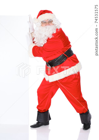 Santa Claus pushes blank white wall, advertisement banner with copy space. Isolated on white background. Full length portrait 74531575