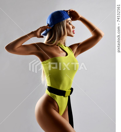Sexy fitness pretty woman in yellow swimsuit and 74532561