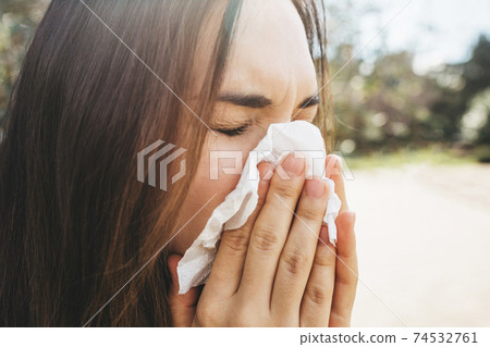 The woman blows her nose 74532761