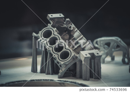 Man is holding object printed on metal 3d printer. Man is holding object printed on metal 3d printer. 74533696