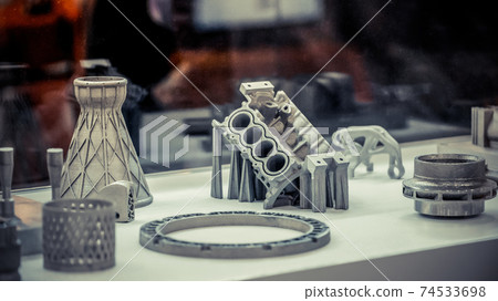 Man is holding object printed on metal 3d printer. 74533698