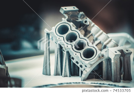 Man is holding object printed on metal 3d printer. Man is holding object printed on metal 3d printer. 74533705