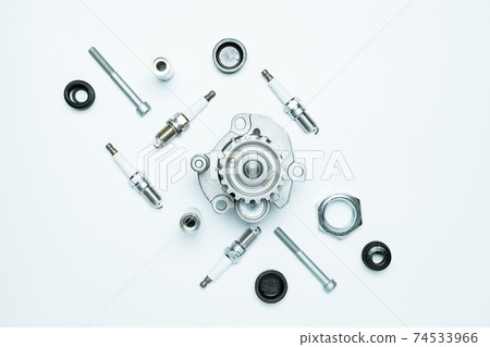 Car motor parts. Auto motor mechanic spare or automotive piece on white background. Set of new metal car part. Flat lay, top view, copy space. Car motor parts. Auto motor mechanic spare or automotive piece on white background. Set of new metal car part. Flat lay, top view, copy space. 74533966