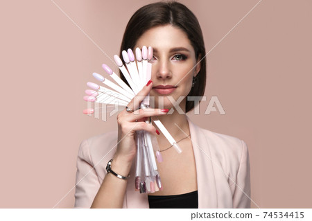 Manicurist in working form with tools in hand. Nail photo content Manicurist in working form with tools in hand. Nail photo content 74534415
