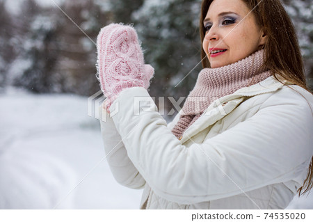 the woman making snowball in the winter park the woman making snowball in the winter park 74535020