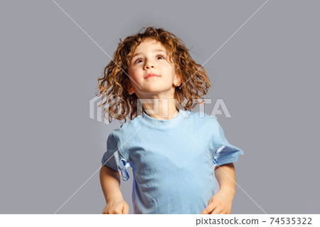 little girl jumps on a gray background little girl jumps on a gray background 74535322
