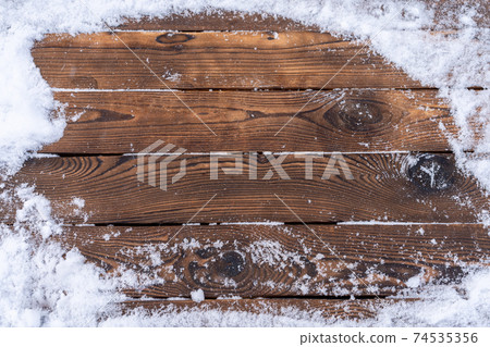 Winter background. Empty wooden plank with snow border, copy space for text 74535356