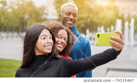 Multi ethnic friends outdoor. Diverse group people Afro american asian spending time together 74535467